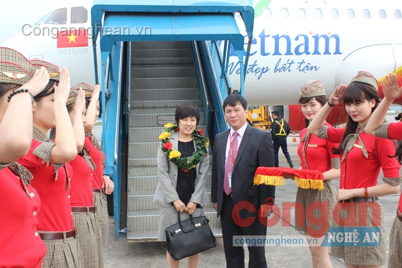 Đại diện hãng hàng không Vietjet đón chào và tặng hoa cho hành khách thứ 10 triệu