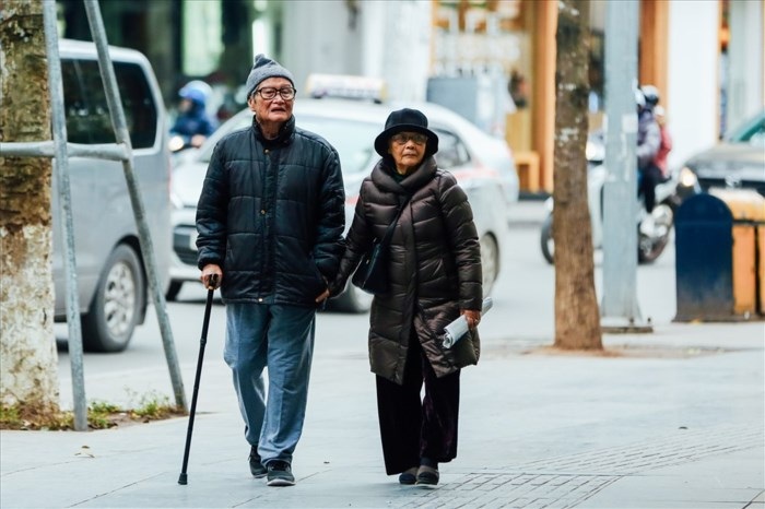 Nhiệt độ xuống thấp, người dân phải mang áo ấm, trùm kín người để bớt lạnh mỗi khi ra đường. (Ảnh: Báo Lao động)