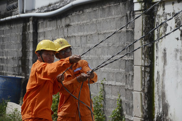 Nhân viên Điện lực Long Điền kéo dây điện tại khu vực xã Tam Phước, huyện Long Điền.