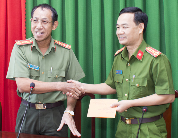 Đại tá Bùi Văn Thảo (bên trái), Giám đốc Công an tỉnh tuyên dương và trao thưởng 10 triệu đồng cho Phòng Cảnh sát hình sự.