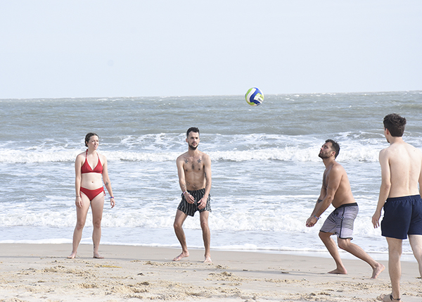 Du khách chơi bóng chuyền trên bãi biển.