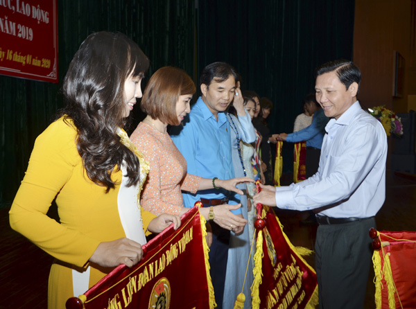 Ông Mai Minh Quang, Phó Trưởng Ban Dân vận Tỉnh ủy trao Cờ thi đua của Tổng LĐLĐ Việt Nam cho các công đoàn cơ sở có phong trào thi đua xuất sắc năm 2019.