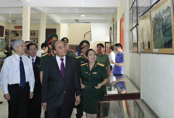 Thủ tướng Nguyễn Xuân Phúc và các đại biểu thăm Phòng truyền thống của Trường Sĩ quan Lục quân 2.  Ảnh: Thống Nhất