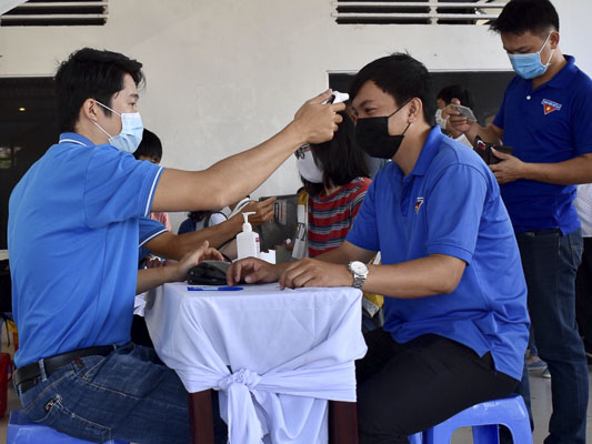 ĐVTN đến hiến máu được kiểm tra thân nhiệt vào ngày 14/3 tại Nhà Văn hóa Thanh niên tỉnh. Ảnh: PHI DŨNG