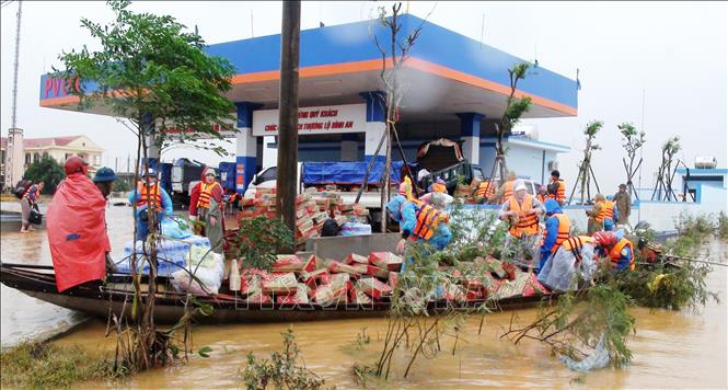 Chuyển hàng cứu trợ tới người dân ở xã Hàm Ninh, huyện Quảng Ninh, Quảng Bình. Ảnh: TTXVN