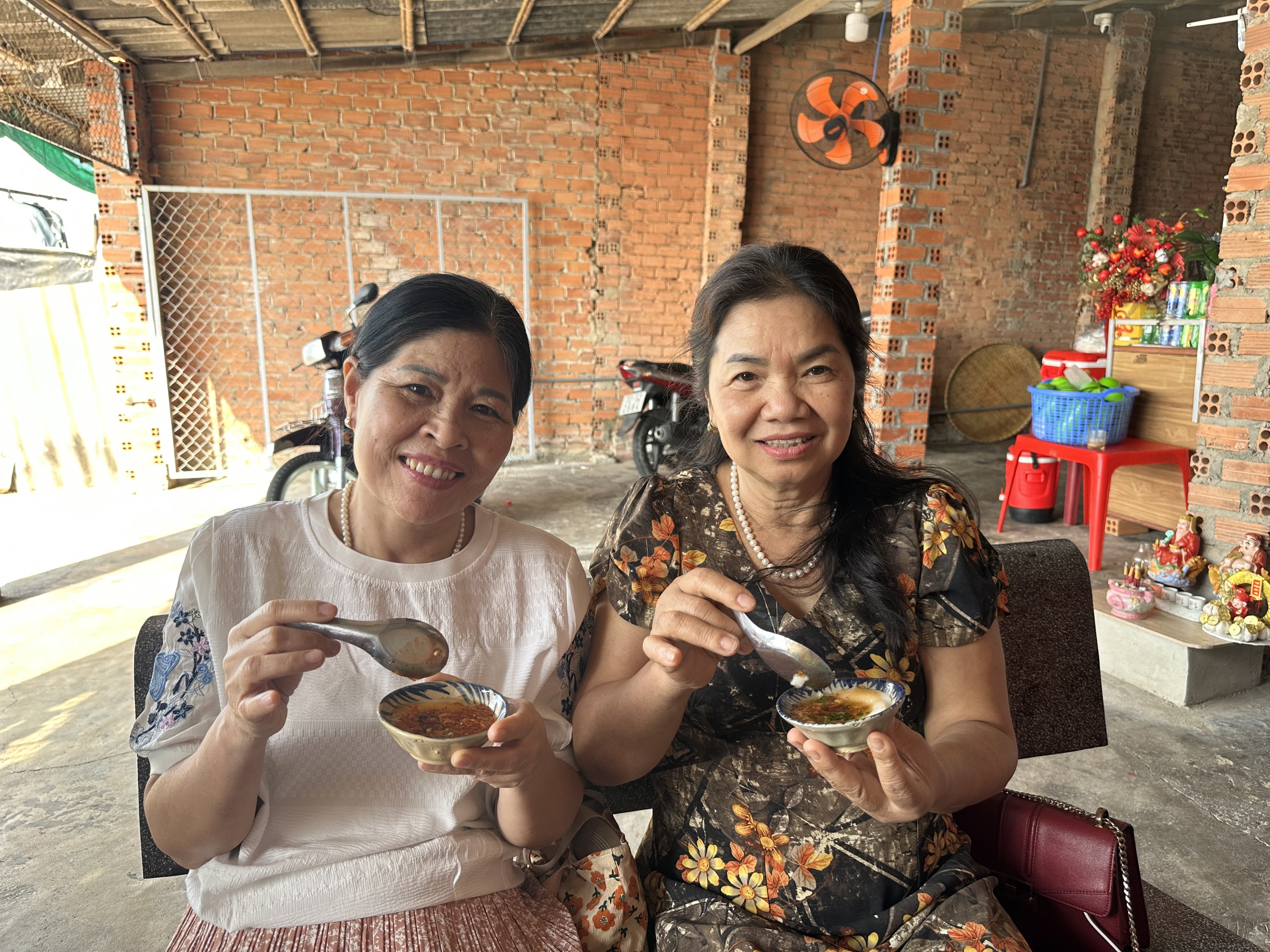 Bà Nguyễn Minh Hà (phải) cùng người thân thưởng thức món bánh chén Phước Tỉnh.