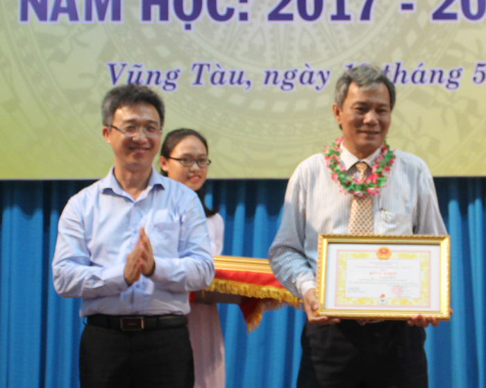 Đồng chí Đặng Minh Thông, Tỉnh ủy viên, Phó Chủ tịch UBND tỉnh trao Bằng khen của UBND tỉnh cho thầy Lê Quốc Hùng, Hiệu trưởng Trường THPT Chuyên Lê Quý Đôn.