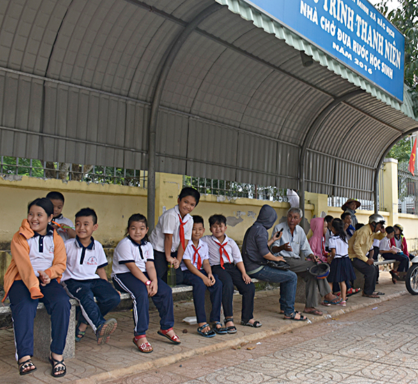 HS chờ phụ huynh đến đón trong “Nhà chờ  HS” trước  Trường Tiểu học Nguyễn Du.
