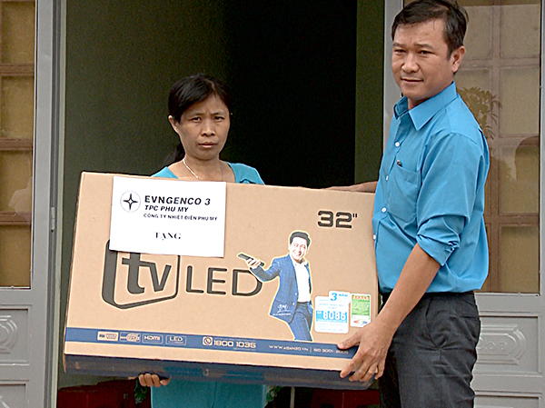 Anh Trần Thái, Phó Chủ tịch Công đoàn Công ty Nhiệt điện Phú Mỹ trao tặng 1 ti vi nhân dịp bà Nguyễn Thị Nga được căn nhà mới.