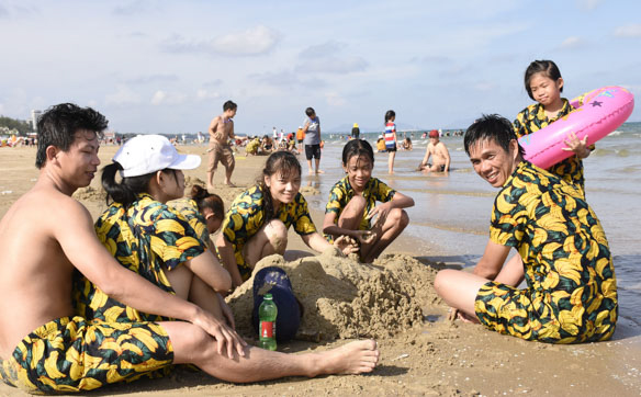 Du khách chơi đắp cát tại Bãi Sau.