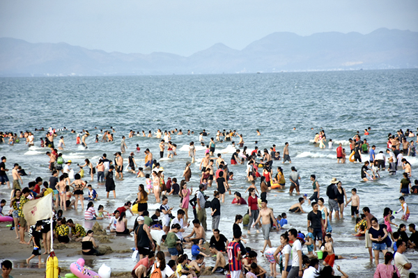 Du khách chen chân tắm biển. Ảnh: THÀNH HUY