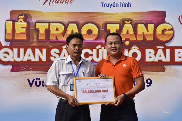 Ông Trần Anh Tuấn (bìa phải), Giám đốc FPT Telecom Chi nhánh Vũng Tàu trao bảng tượng trưng số tiền tài trợ trang bị ghế cứu hộ cho đại diện Ban quản lý các KDL TP.Vũng Tàu.
