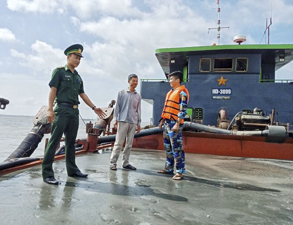 Lực lượng chức năng kiểm tra khối lượng cát sông khai thác không phép đang vận chuyển trên tàu HD3899 được phát hiện, bắt giữ ngày 3/8 vừa qua. Ảnh: PHƯƠNG NAM