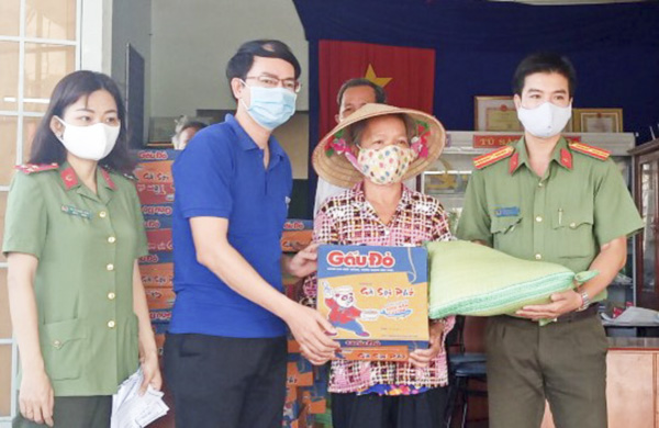 Đại diện Huyện Đoàn Long Điền và Đoàn Thanh niên Công an tỉnh trao quà cho người nghèo xã Phước Hưng, huyện Long Điền. Ảnh: MINH THANH