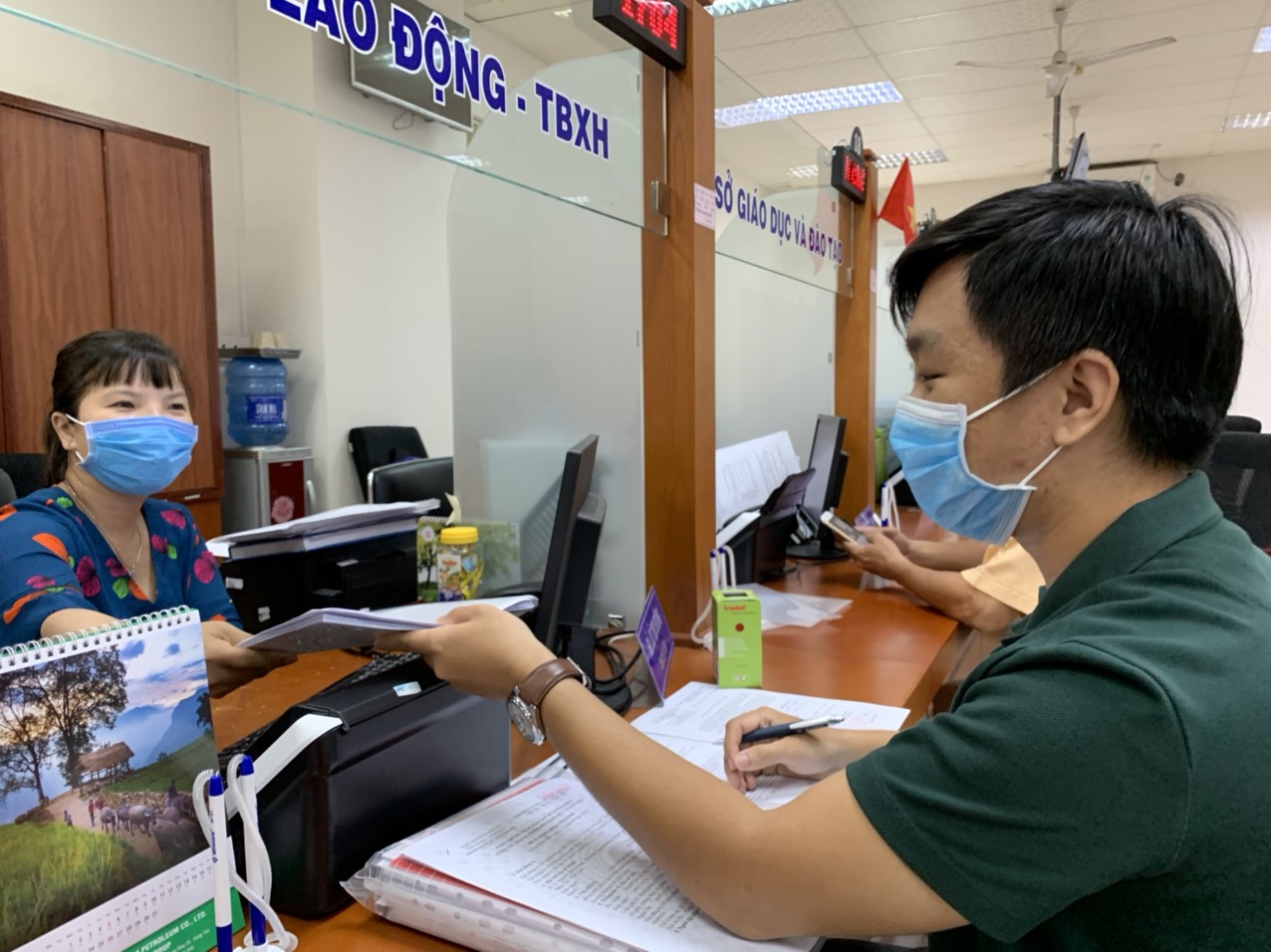 Người dân đến giao dịch và công chức Trung tâm phục vụ hành chính công tỉnh đều đeo khẩu trang trong khi làm việc.