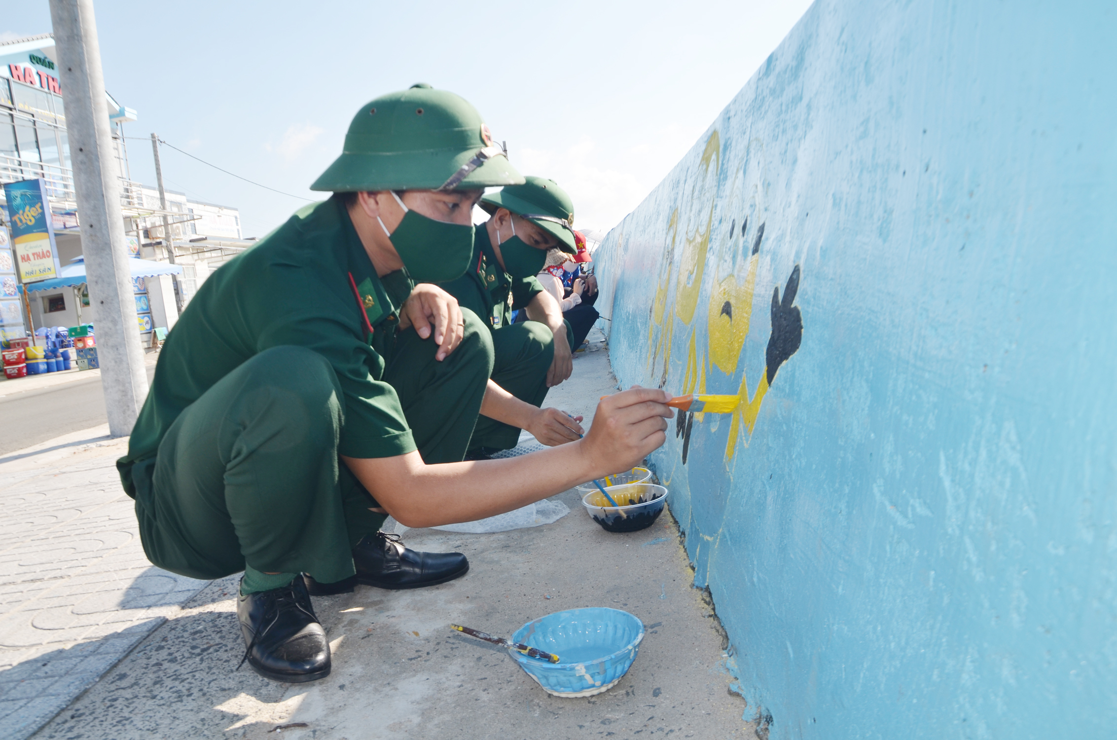 Chiến sĩ Đồn Biên phòng Phước Hải và học sinh Trường THCS Minh Đạm tham gia vẽ  “Bức họa ven biển” tại bờ kè Phước Hải (huyện Đất Đỏ).