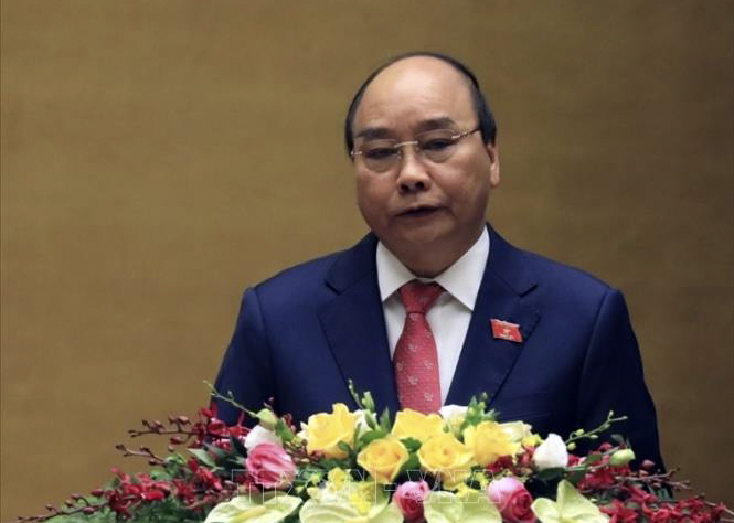 Thủ tướng Chính phủ Nguyễn Xuân Phúc trình bày Báo cáo kết quả thực hiện kế hoạch phát triển kinh tế - xã hội năm 2020 và 5 năm 2016-2020, dự kiến kế hoạch phát triển kinh tế - xã hội năm 2021, mục tiêu chủ yếu và một số nhiệm vụ, giải pháp phát triển kinh tế - xã hội giai đoạn 2021-2025. Ảnh: Văn Điệp/TTXVN