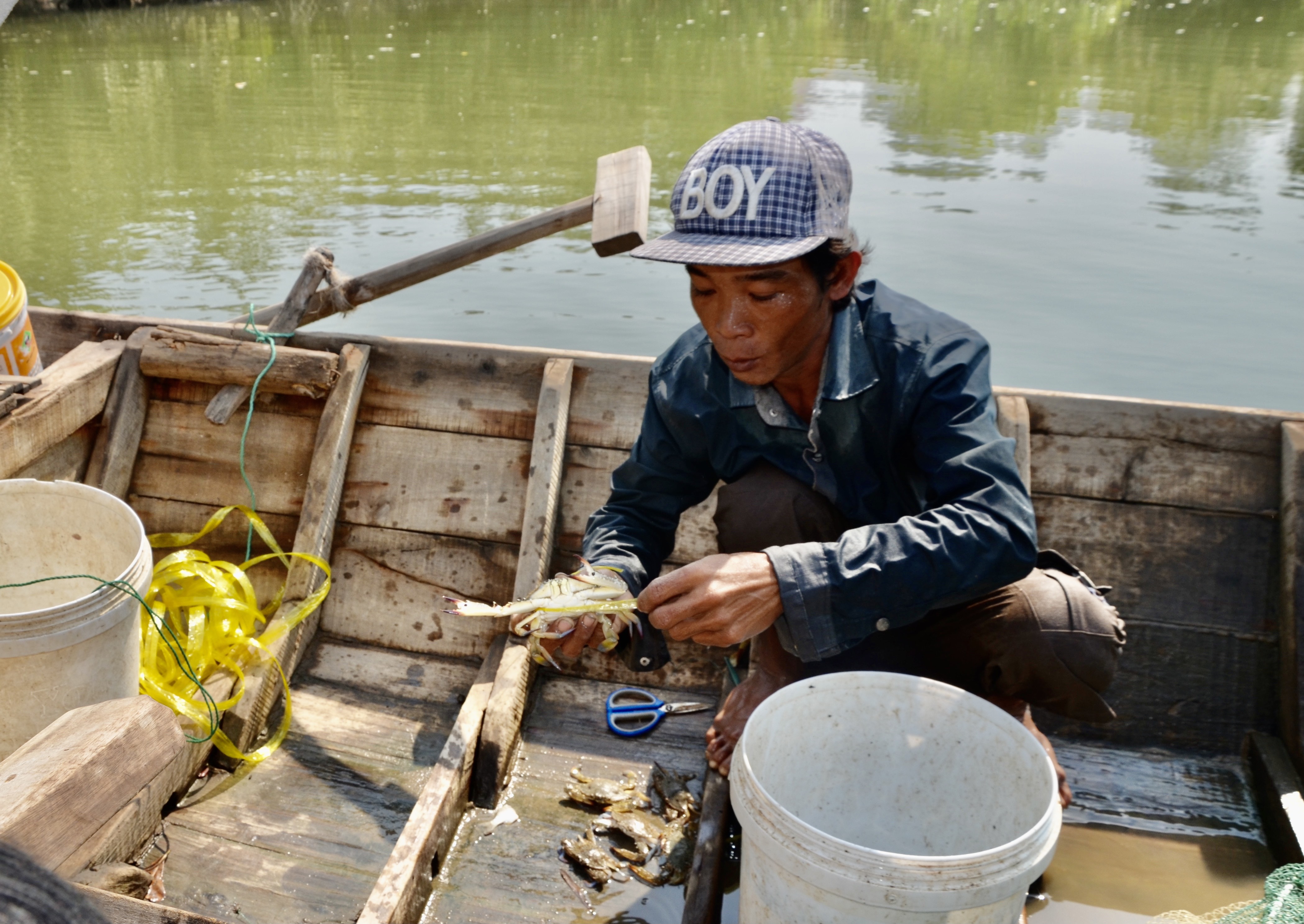 Ngư dân đánh bắt hải sản trên sông.
