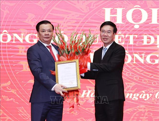 Ông Võ Văn Thưởng, Ủy viên Bộ Chính trị, Thường trực Ban Bí thư trao Quyết định và tặng hoa chúc mừng ông Đinh Tiến Dũng giữ chức Bí thư Thành ủy Hà Nội. Ảnh: TTXVN