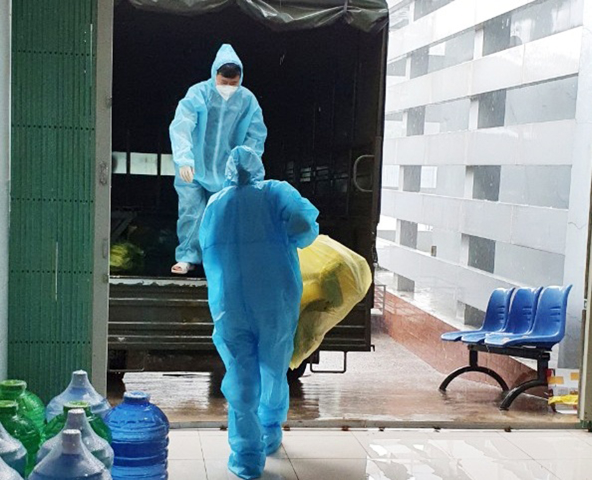 Nhân viên TTYT huyện Long Điền vận chuyển trang thiết bị lên xe, chuẩn bị di chuyển đến điểm lấy mẫu xét nghiệm.