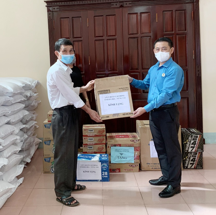 Ông Huỳnh Sơn Tuấn, Chủ tịch LĐLĐ tỉnh trao phần quà cho đại diện UBMTTQ Việt Nam địa phương.