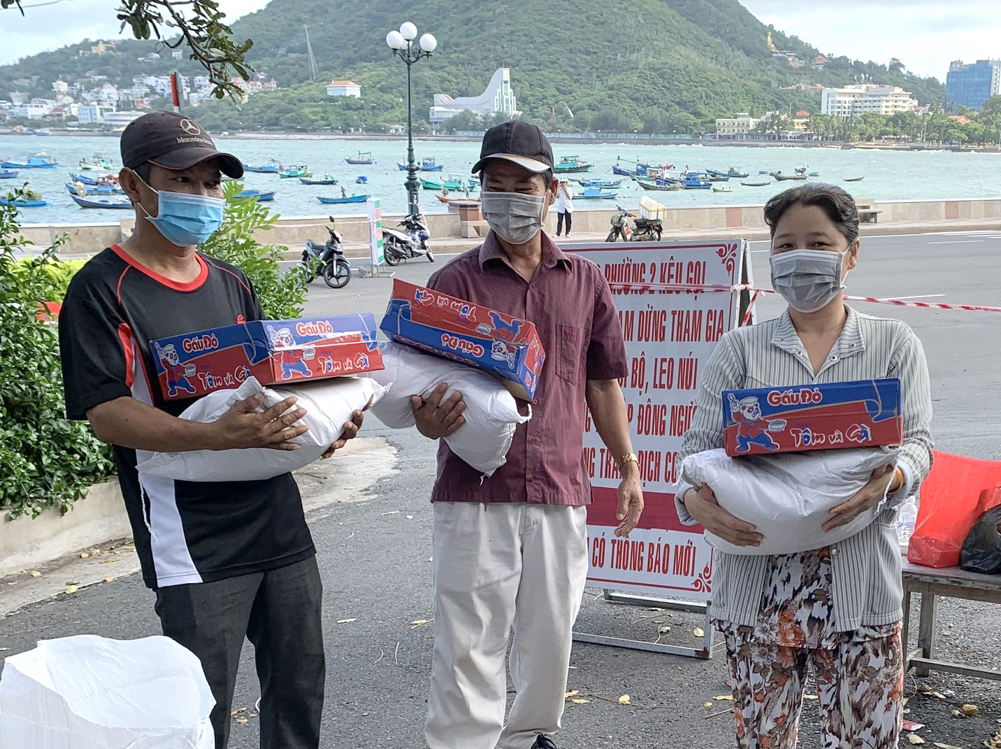 Người dân đến nhận gạo, mì gói tại trụ sở khu phố 1.