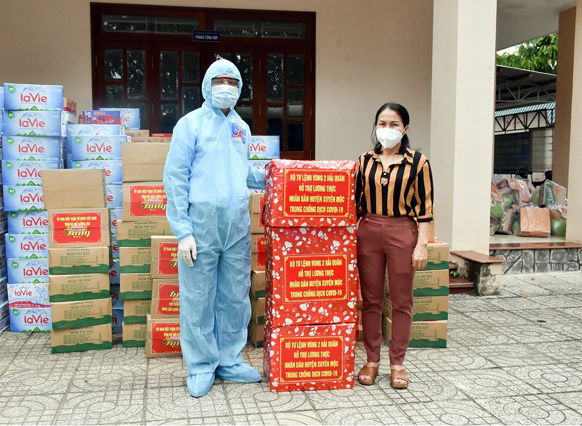Đại diện Chi đội Kiểm ngư số 2 (bên trái)  trao số nhu yếu phẩm ủng hộ cho UBMTTQ Việt Nam huyện Xuyên Mộc.