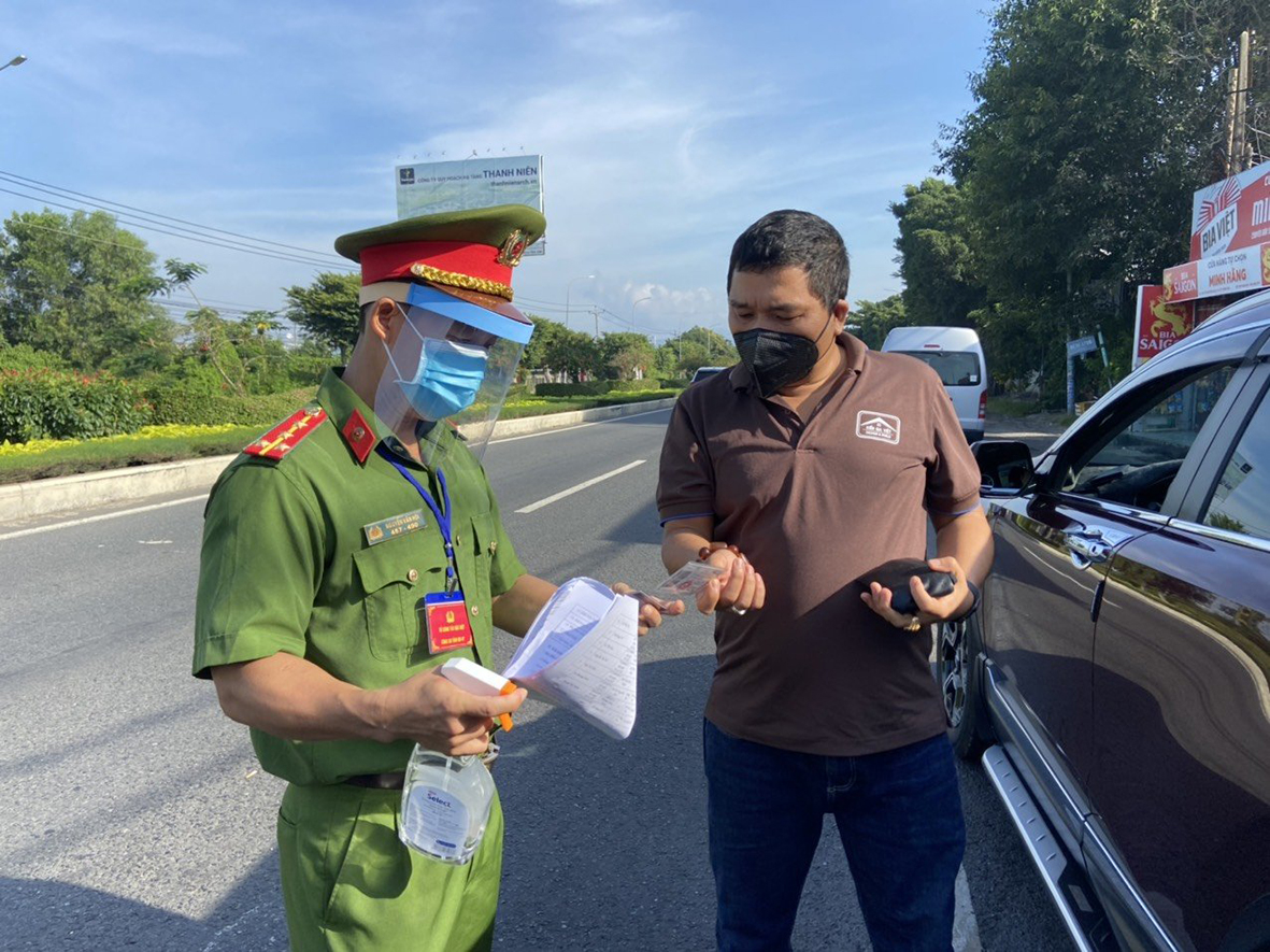Lực lượng công an kiểm tra giấy tờ liên quan đến việc đi ra ngoài của người dân tại chốt kiểm soát cầu Cỏ May, phường 12, TP.Vũng Tàu vào sáng 17/8. Ảnh: QUANG VINH.