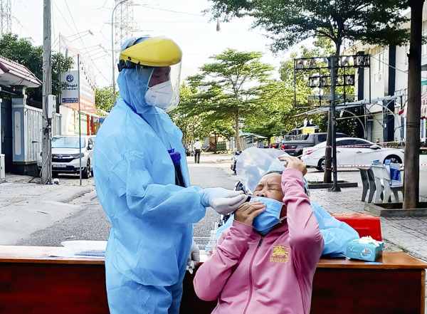Nhân viên y tế lấy mẫu xét nghiệm PCR cho cư dân chung cư Bình An (TP.Vũng Tàu, tỉnh BR-VT). Ảnh: VÂN ANH