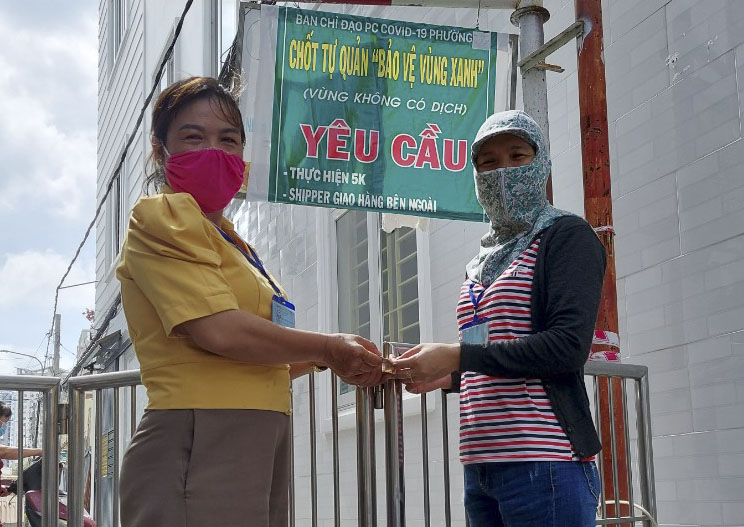 Chị Phạm Thị Hoài Phương, Chi hội trưởng Chi hội Phụ nữ khu phố 2, Hội LHPN phường Thắng Tam (trái) tặng quà cho lực lượng trực chốt bảo vệ vùng xanh tại hẻm 44, Xô Viết Nghệ Tĩnh.