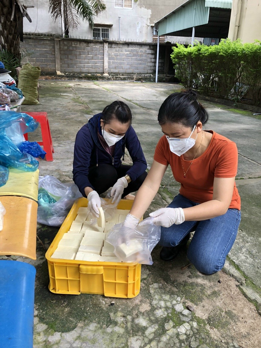 Chị Đỗ Thị Nhạn, Chủ tịch Hội LHPN phường Phước Nguyên, TP.Bà Rịa (phải) phân chia đậu hũ để tặng cho người dân có hoàn cảnh khó khăn trên địa bàn phường.