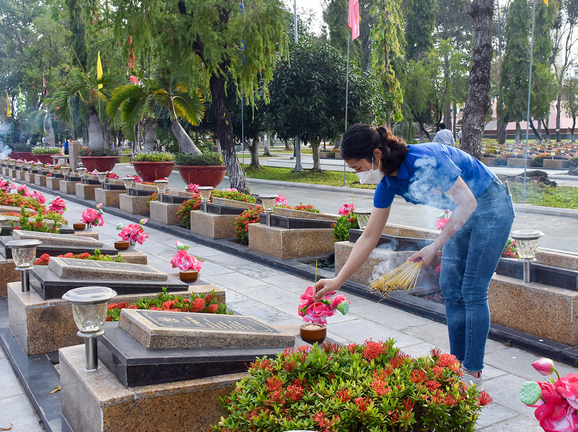 Người dân thắp hương tại các phần mộ liệt sĩ.