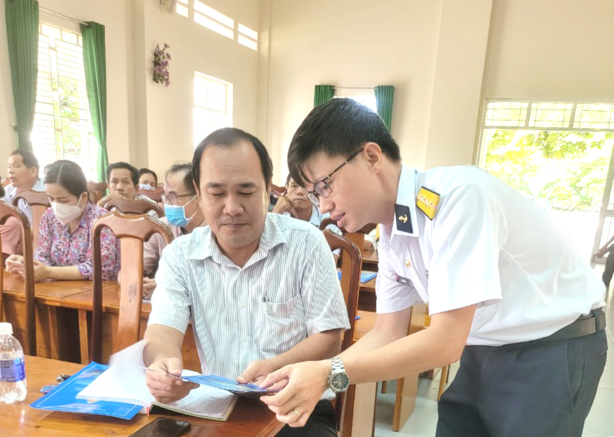 Cán bộ Lữ đoàn 171 phát tờ rơi tuyên truyền về biển, đảo cho cán bộ xã Phước Tỉnh.