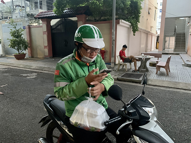 Một Grapfood đang liên lạc với khách để giao hàng tại chung cư 217, Nguyễn Hữu Cảnh, TP.Vũng Tàu.
