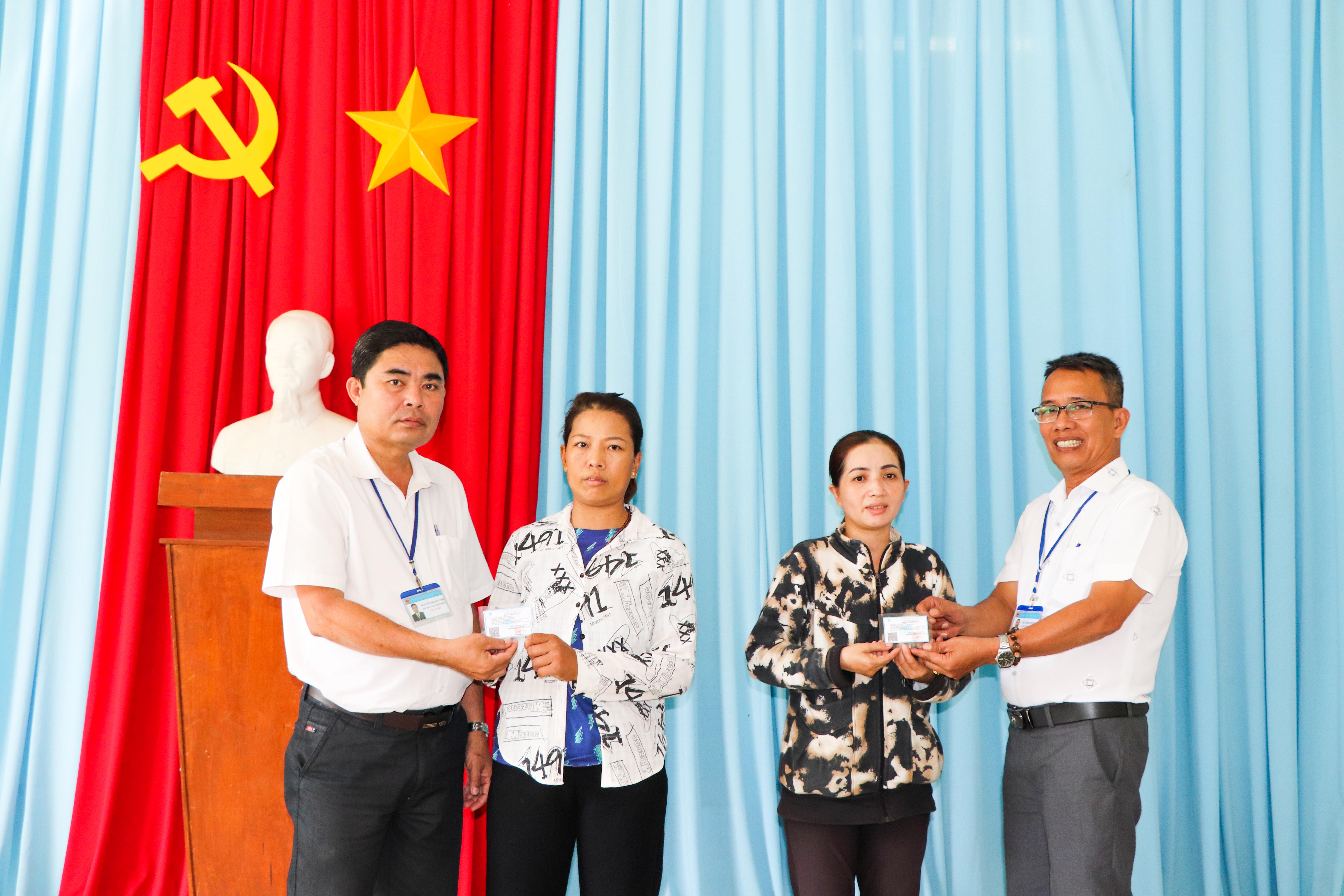 Ông Nguyễn Hoàng Trí (bên trái), Phó Bí thư Thường trực Đảng ủy xã Cù Bị trao tặng thẻ BHYT cho người dân co hoàn cảnh khó khăn vào sáng 17/10. Kinh phí thực hiện do Hội Nông dân xã vận động.