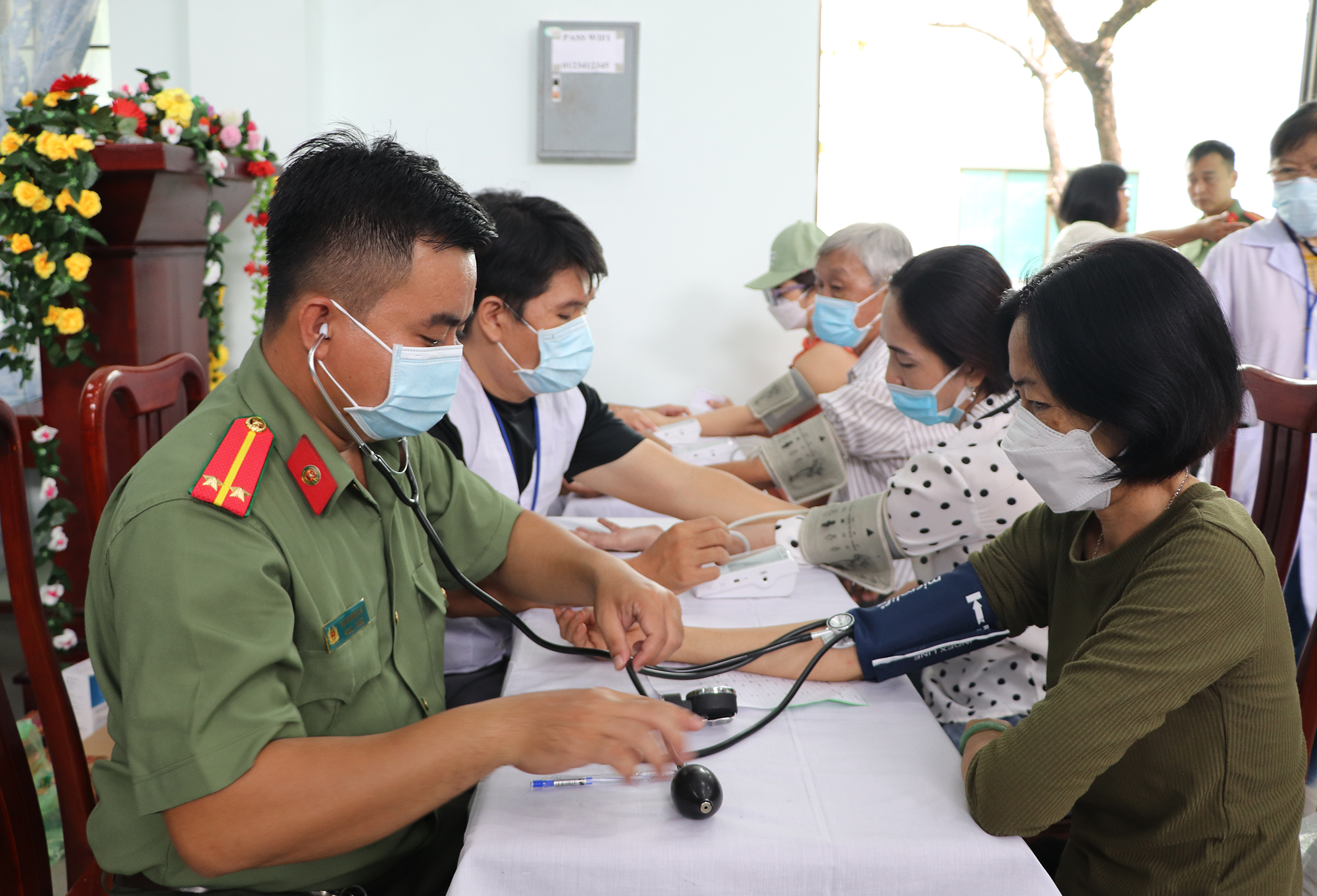 Người dân được kiểm tra huyết áp trước khi vào khám.