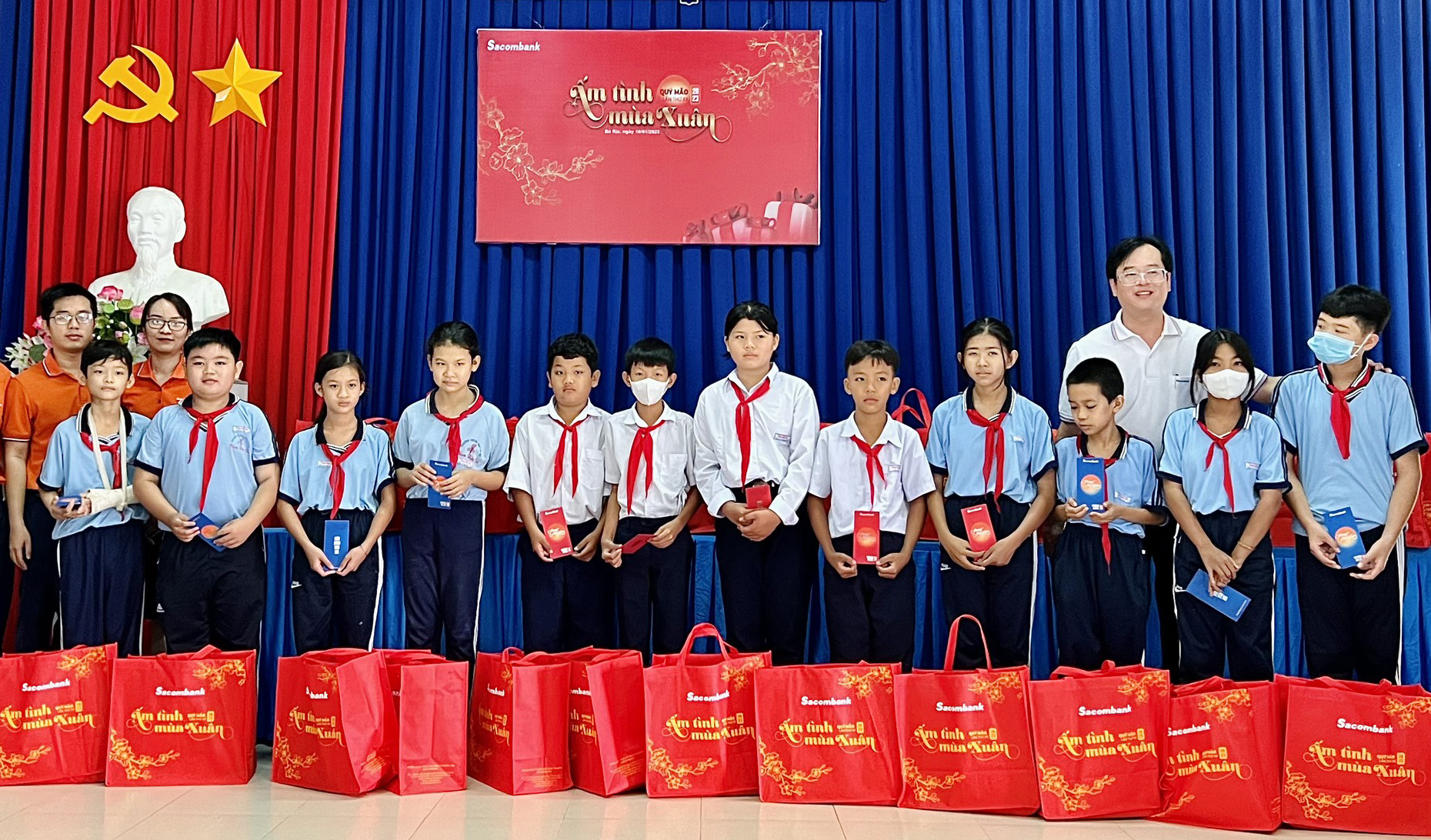 Đại diện Ngân hàng Sacombank Chi nhánh Bà Rịa tặng quà cho các em học sinh có hoàn cảnh khó khăn của Trường THCS Phạm Hữu Chí (xã An Ngãi, huyện Long Điền).