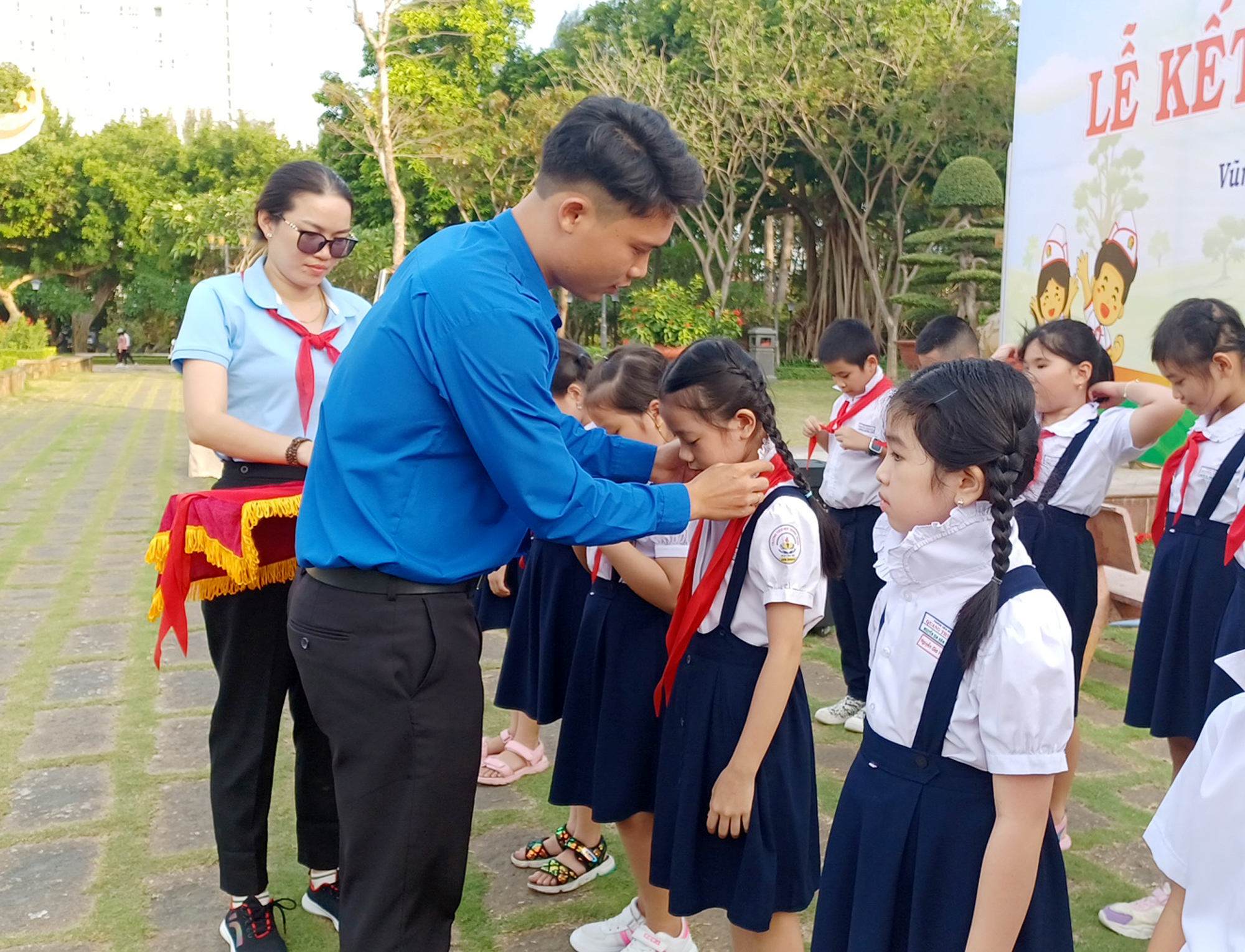 Anh Đồng Thanh Tùng, Phó Bí thư Đoàn TNCS Hồ Chí Minh TP. Vũng Tàu trao khăn quàng đỏ cho các bạn HS trường TH Quang Trung tại lễ kết nạp Đội.