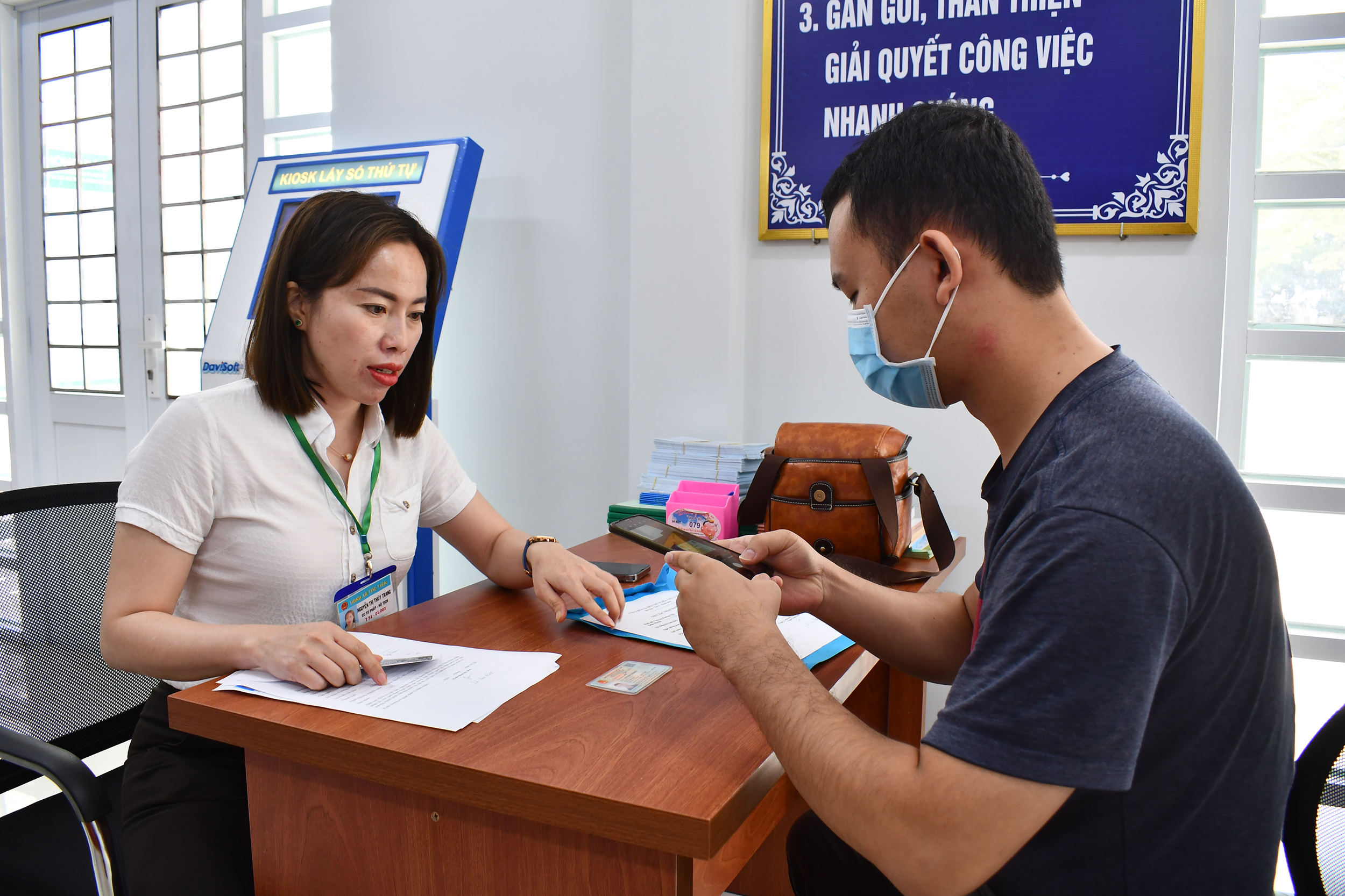 Thành viên tổ hướng dẫn, hỗ trợ thực hiện DVCTT xã Tóc Tiên, TX. Phú Mỹ hướng dẫn người dân làm thủ tục.