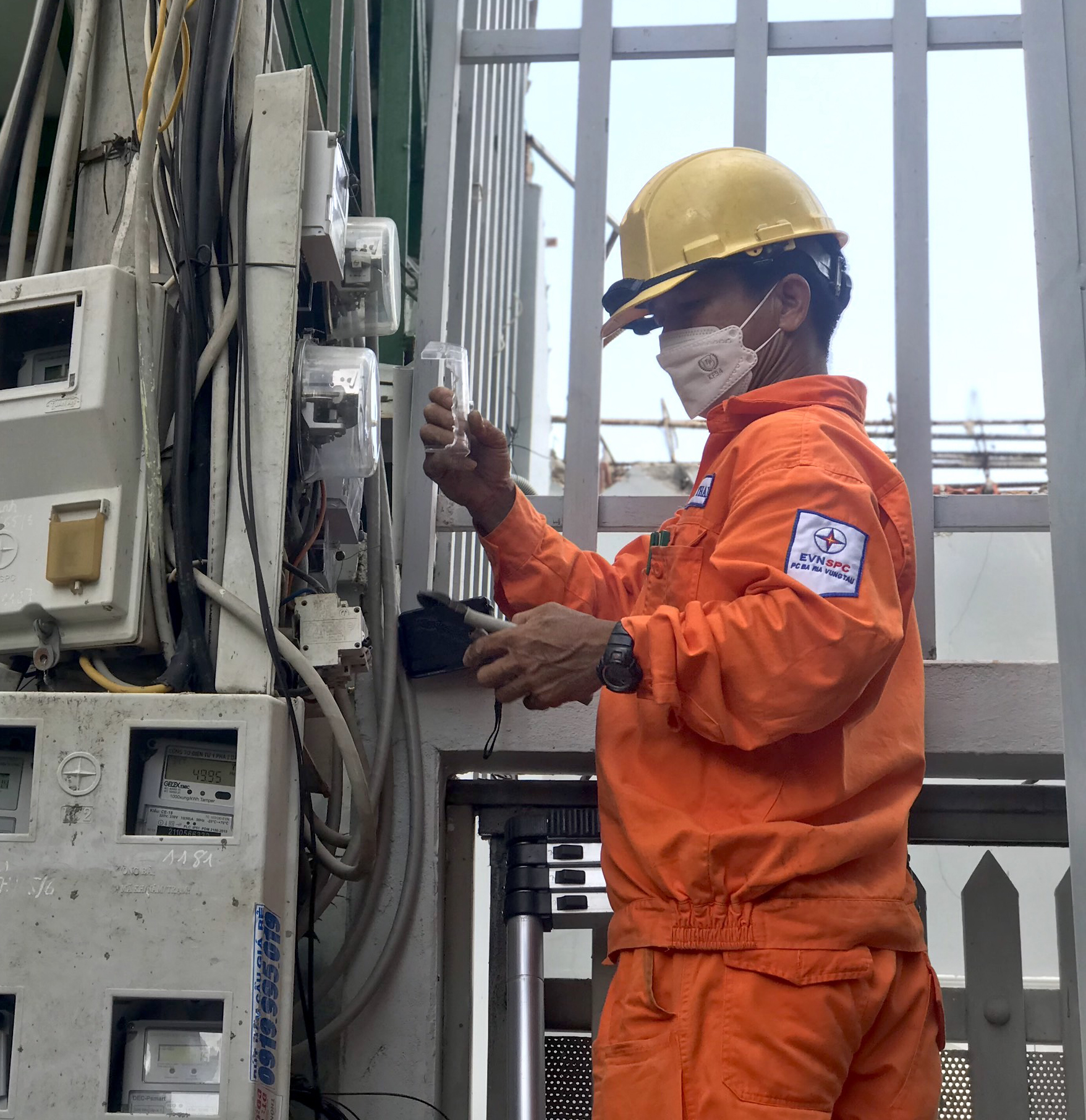 Nhân viên điện lực TP.Vũng Tàu thay thế công tơ cơ bằng công tơ điện tử cho khách hàng.