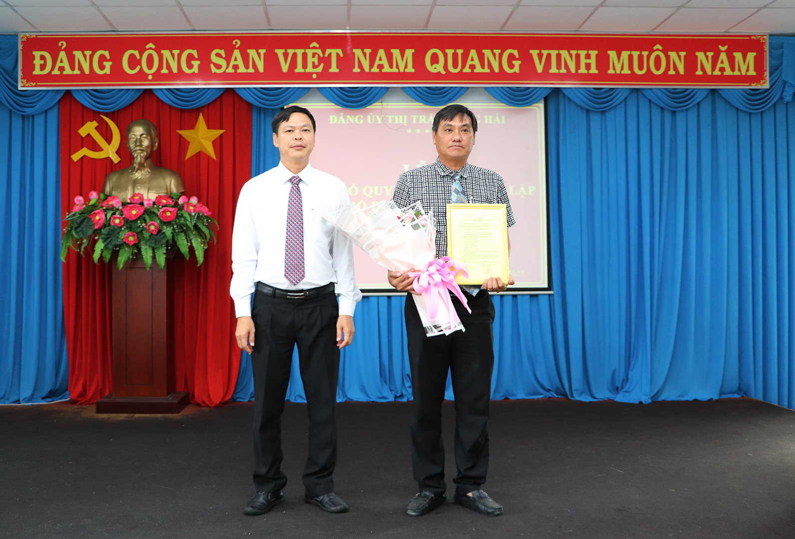 Ông Ngô Thanh Phúc, Bí thư Đảng ủy Thị trấn Long Hải trao Quyết định thành lập chi bộ Doanh nghiệp số 2 tới ông Trần Quốc Nhẫn.