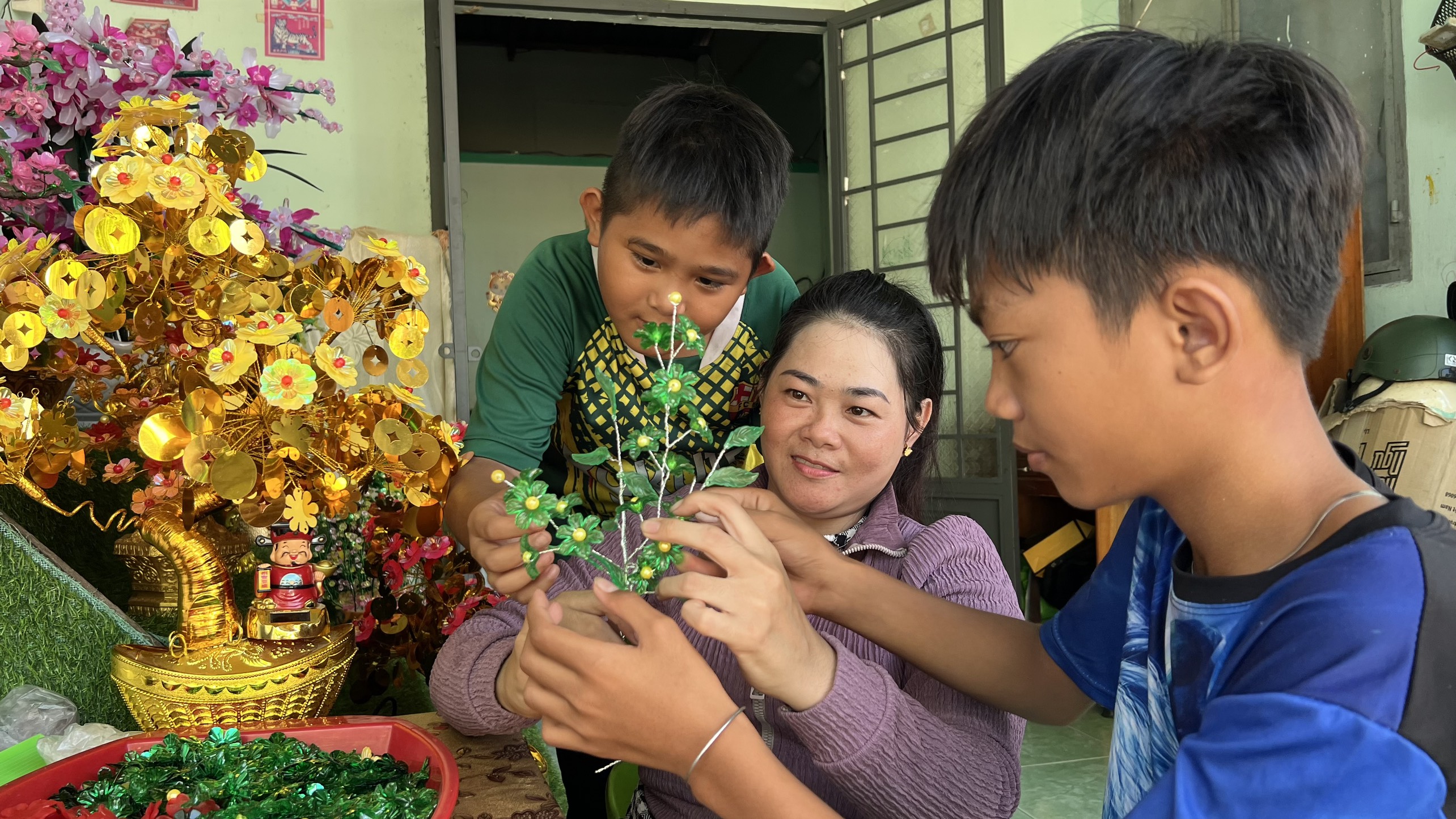 Con trai chị Linh phụ mẹ làm kết hoa pha lê.
