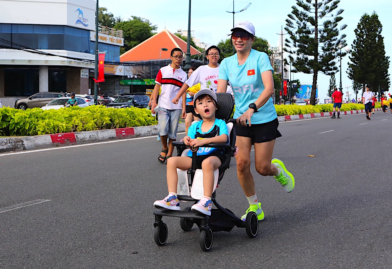 Biểu cảm dễ thương của em bé khi mẹ đẩy xe chạy quá nhanh - ảnh Ngoc Khoi.