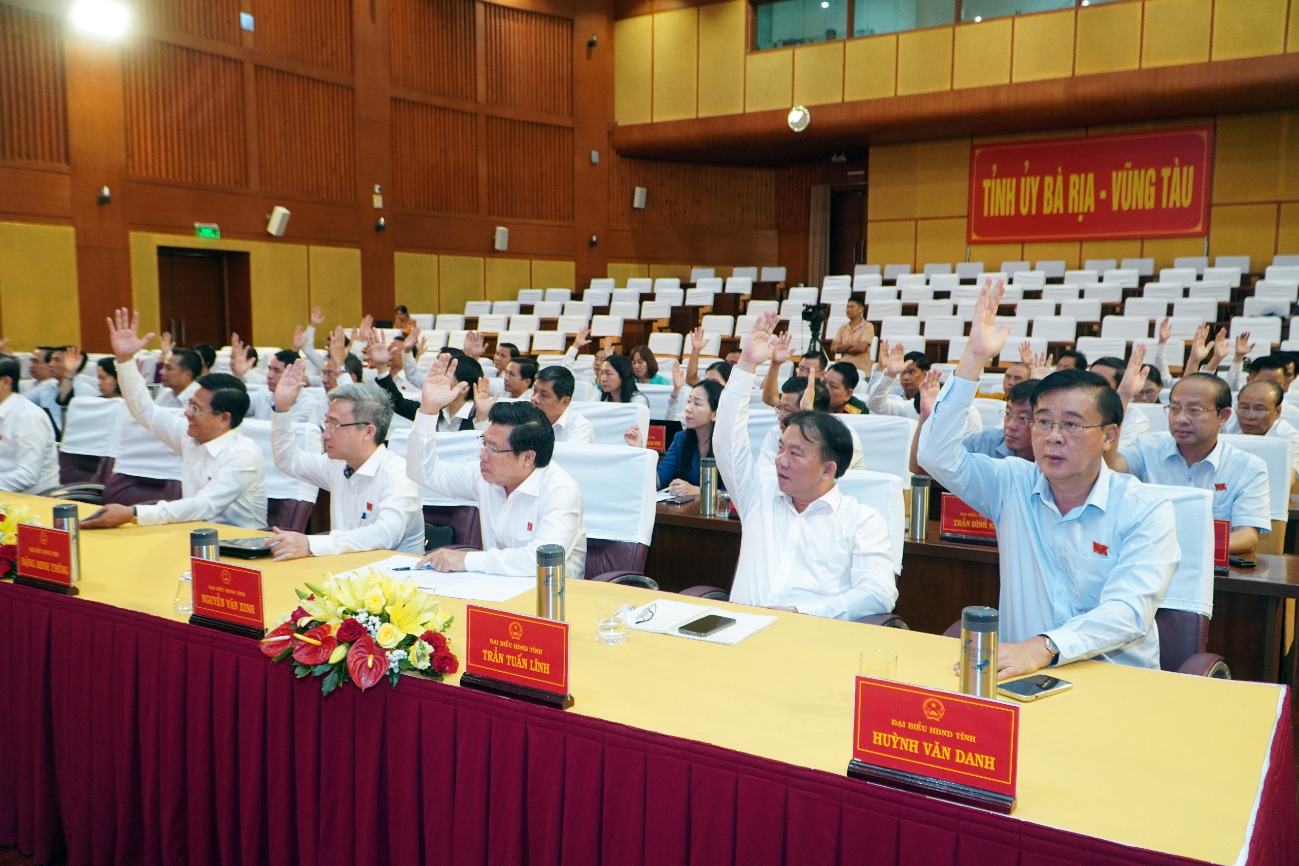 Các đại biểu HĐND tỉnh biểu quyết thông qua Nghị quyết có nội dung sáp nhập huyện Long Điền và huyện Đất Đỏ. Ảnh: QUANG VINH