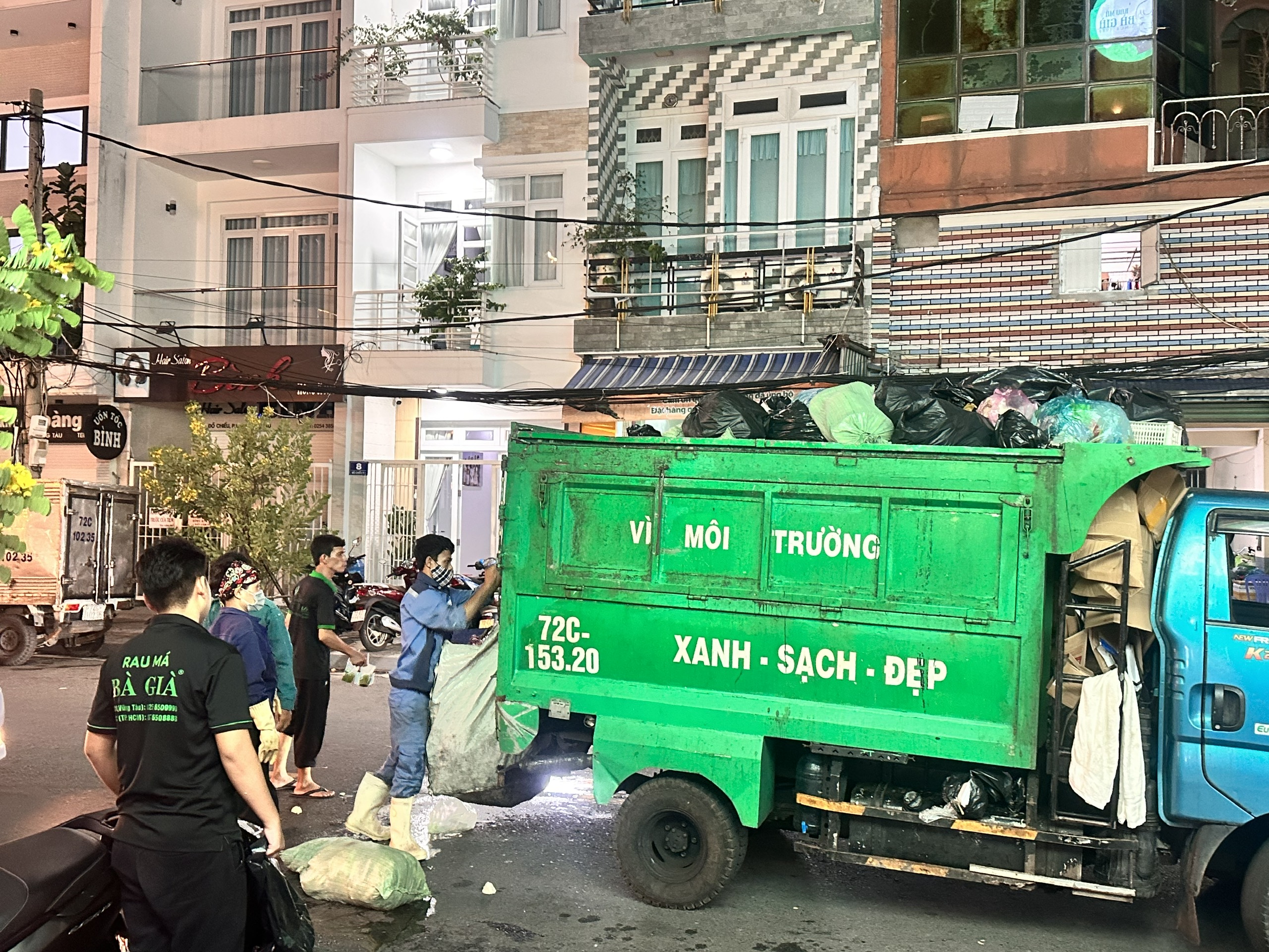 Để bảo đảm không có rác ứ đọng trong khu dân cư, dọc đường công nhân môi trường phải làm việc suốt đêm. Trong ảnh: Thu gom rác tối 29 Tết trên đường Đồ Chiểu
