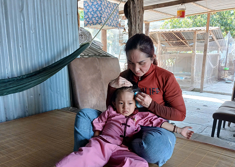 Chị Trinh chăm sóc bé Khánh Chi trong thời gian về nhà chờ lo chi phí cho những lần điều trị bệnh tiếp theo.